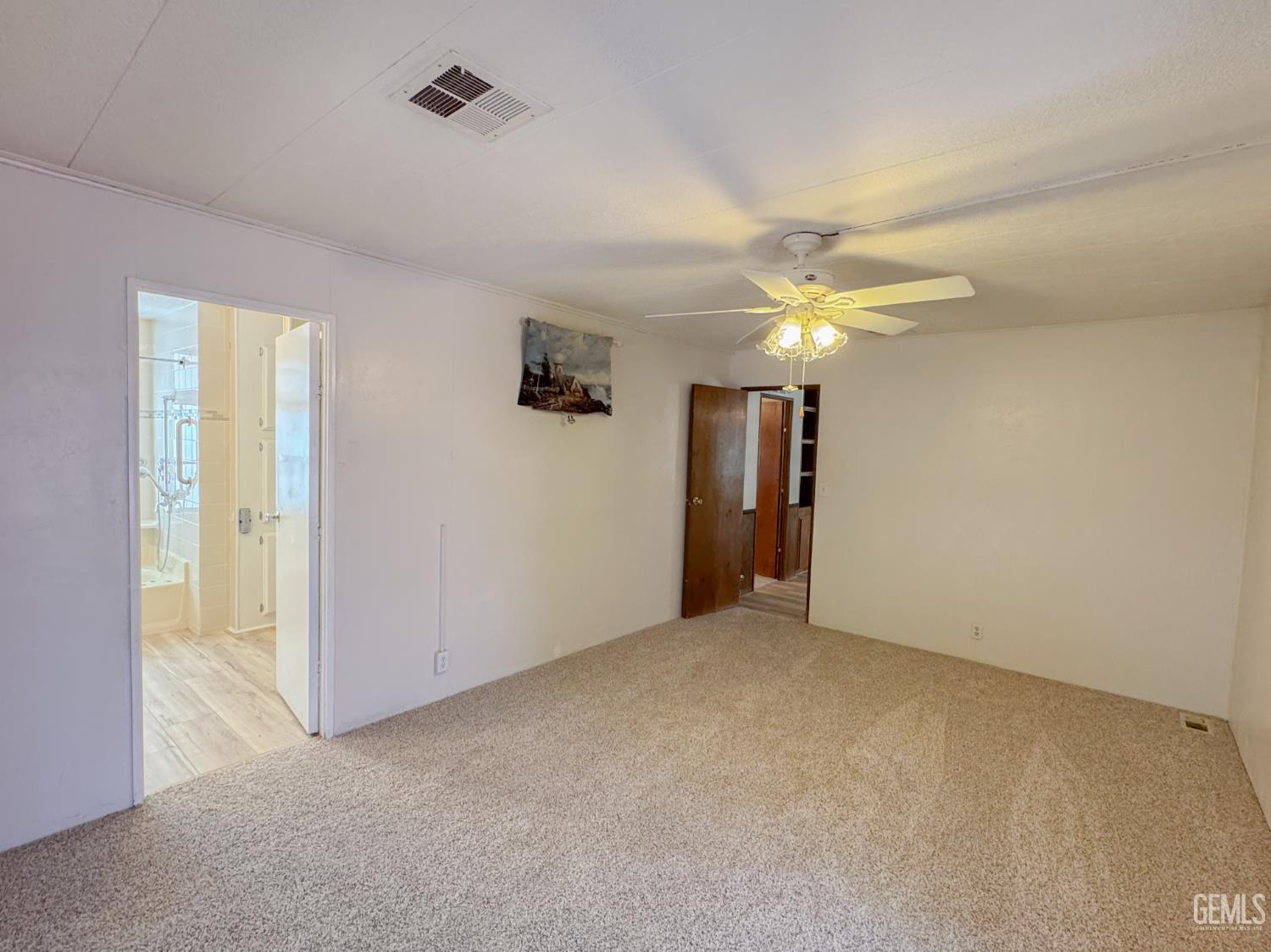 Undisclosed Address Bakersfield, CA 93306 - Photo 29 of 41 an empty room with closet and a chandelier fan