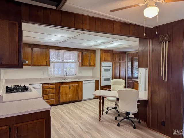 a kitchen with sink cabinets and dining table chair