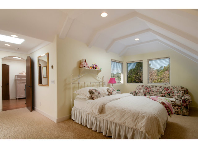 26156 Ladera Drive Carmel, CA 93923 - Photo 16 of 22 a bedroom with a bed and a large mirror