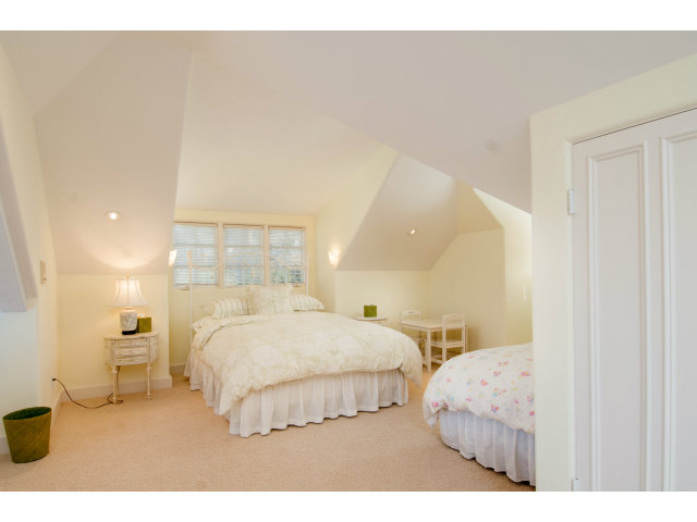 26156 Ladera Drive Carmel, CA 93923 - Photo 17 of 22 a bedroom with a bed and a night stand