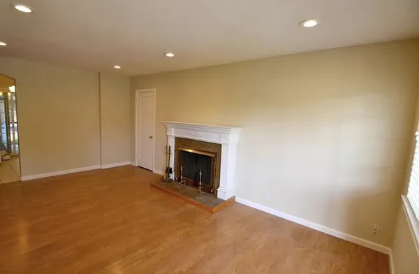 a view of an empty room with a fireplace