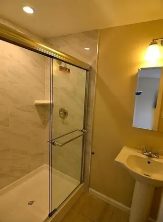 a bathroom with a shower and a sink