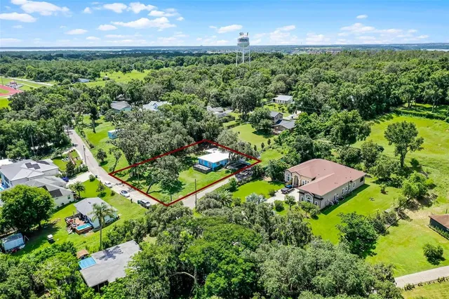 an aerial view of a residential houses with outdoor space and street view