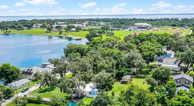 an aerial view of a city with lots of residential buildings ocean and mountain view