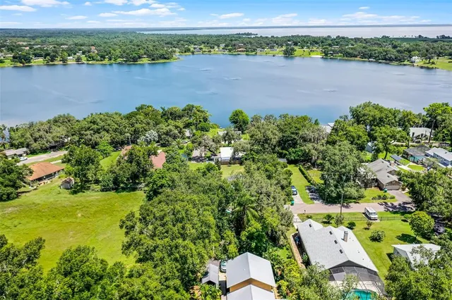 an aerial view of a houses with a lake view