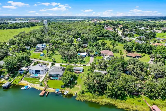 an aerial view of residential houses with outdoor space and street view