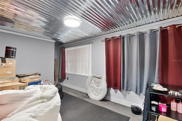 a spacious bedroom with a bed and a window