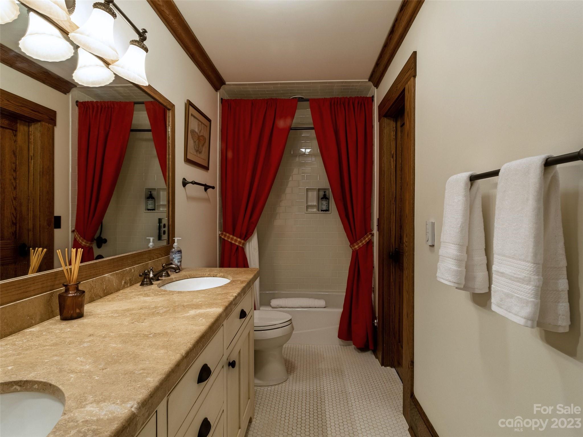 100 Boar Ridge Road Sylva, NC 28779 - Photo 25 of 48 a bathroom with a granite countertop sink and a mirror