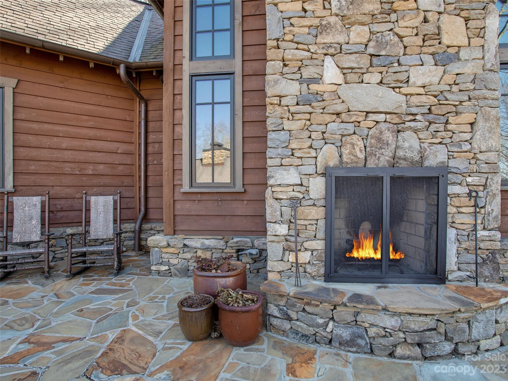 100 Boar Ridge Road Sylva, NC 28779 - Photo 32 of 48 a view of a backyard with chairs and fire pit
