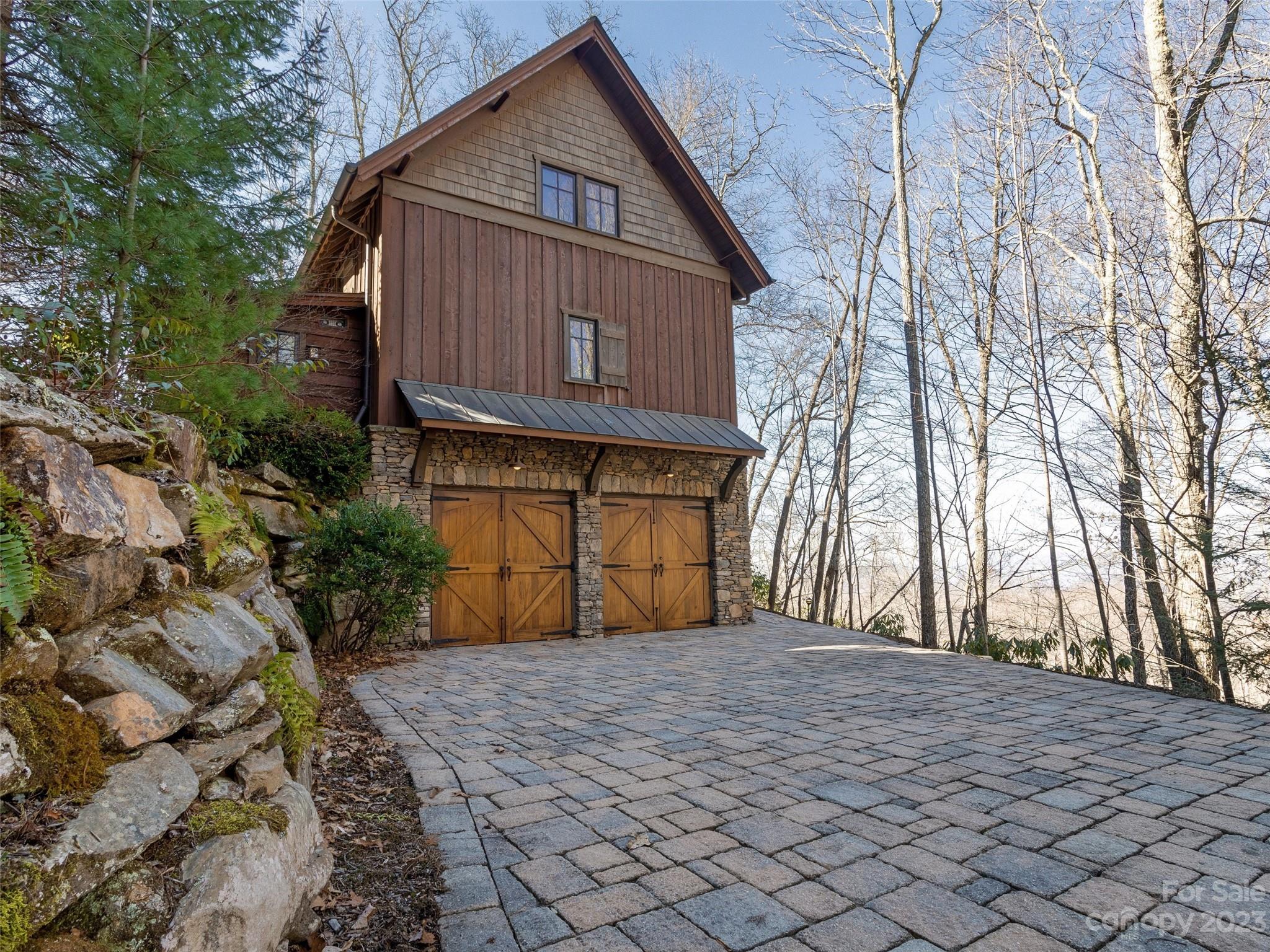 100 Boar Ridge Road Sylva, NC 28779 - Photo 37 of 48 a front view of a house with a yard and garage