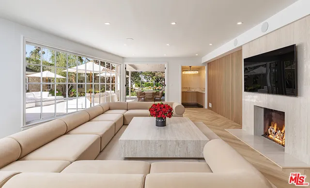 a living room with fireplace furniture and a flat screen tv