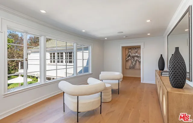 a spacious bedroom with a bed and a flat screen tv