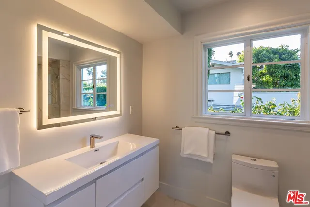 a spacious bedroom with a large bed and a fireplace