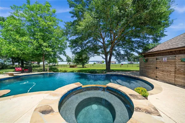 a view of swimming pool with garden and trees