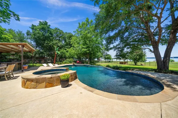 a view of a swimming pool with a yard