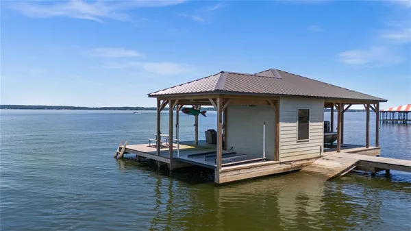 a view of a lake with a lounge chair
