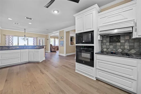 a kitchen with stainless steel appliances a refrigerator sink and microwave