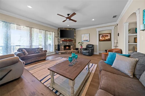 a living room with furniture a fireplace and a flat screen tv