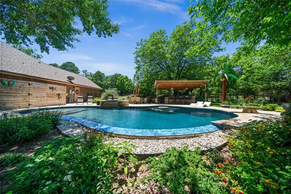 a view of a swimming pool with a yard