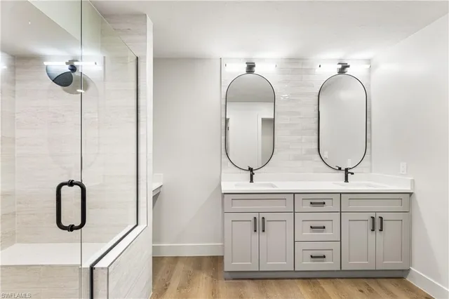 a bathroom with a mirror double vanity and a sink