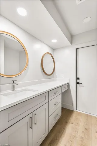 a bathroom with a double vanity sink and a mirror