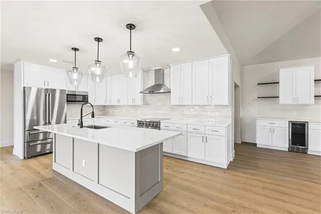 a large kitchen with kitchen island a sink stainless steel appliances and cabinets