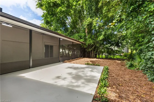 a backyard of a house with large trees