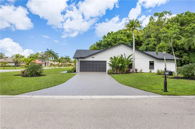 a house with green field in front of it