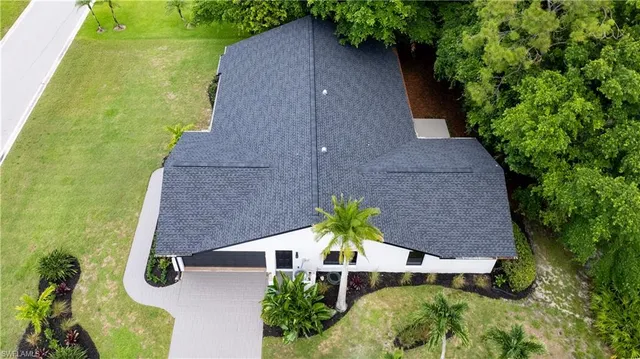 an aerial view of a house with a yard