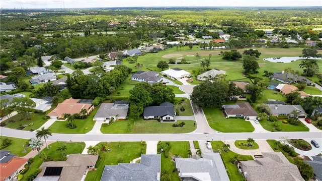 an aerial view of residential houses with outdoor space and river