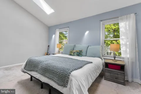 a bedroom with a bed lamps and window