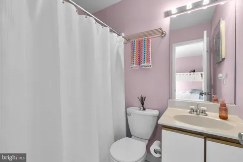 a bathroom with a sink toilet and a mirror
