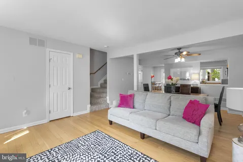 a living room with furniture and kitchen view