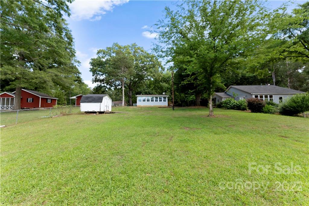 1248 West Shore Drive Lancaster, SC 29720 - Photo 18 of 27 a front view of a house with a garden and trees