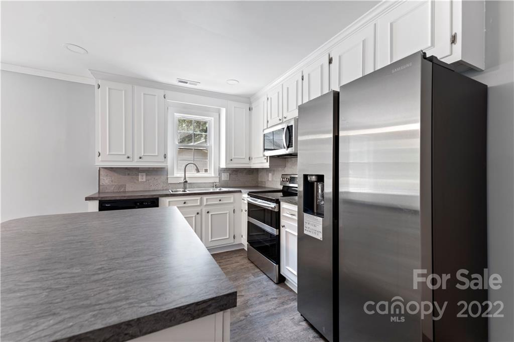 1248 West Shore Drive Lancaster, SC 29720 - Photo 4 of 27 a kitchen with a refrigerator and a sink