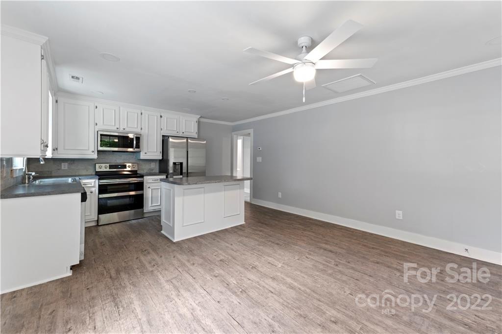 1248 West Shore Drive Lancaster, SC 29720 - Photo 5 of 27 a kitchen with a refrigerator and white cabinets