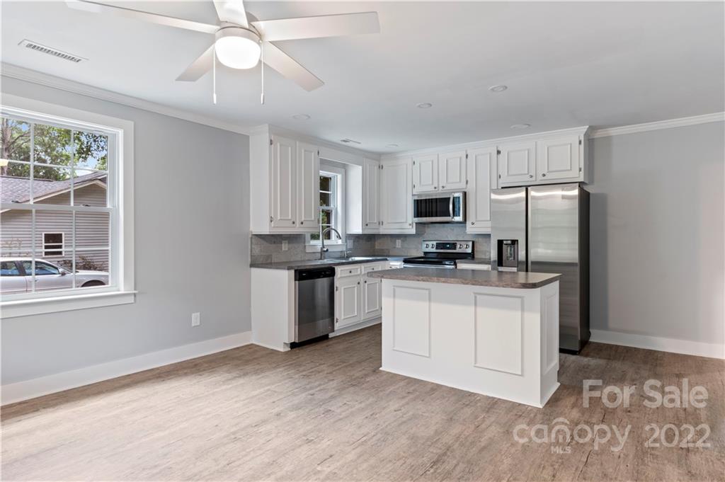 1248 West Shore Drive Lancaster, SC 29720 - Photo 6 of 27 a kitchen with granite countertop white cabinets and stainless steel appliances