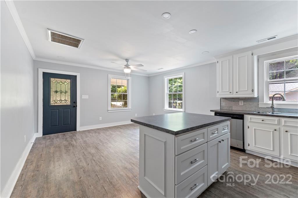 1248 West Shore Drive Lancaster, SC 29720 - Photo 7 of 27 a kitchen with granite countertop a sink a window and cabinets