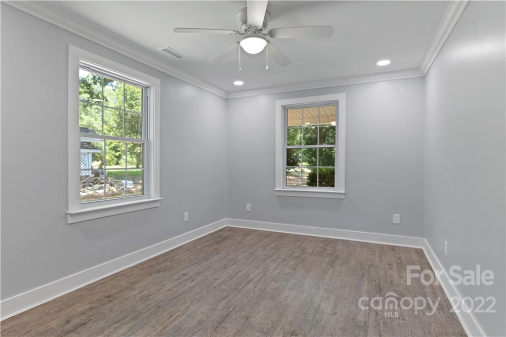 1248 West Shore Drive Lancaster, SC 29720 - Photo 10 of 27 a view of an empty room with wooden floor and a window