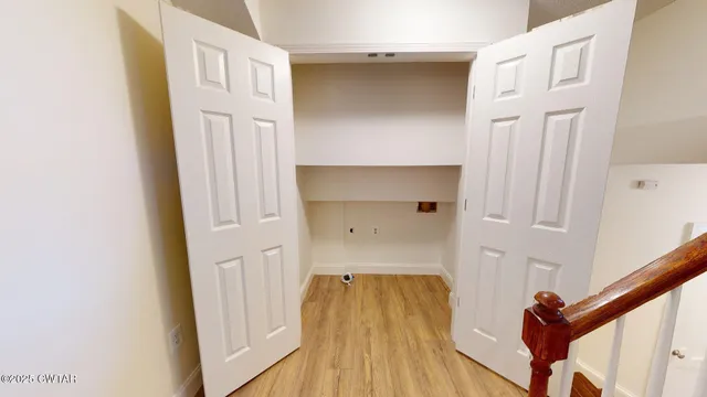 a view of front door with wooden floor