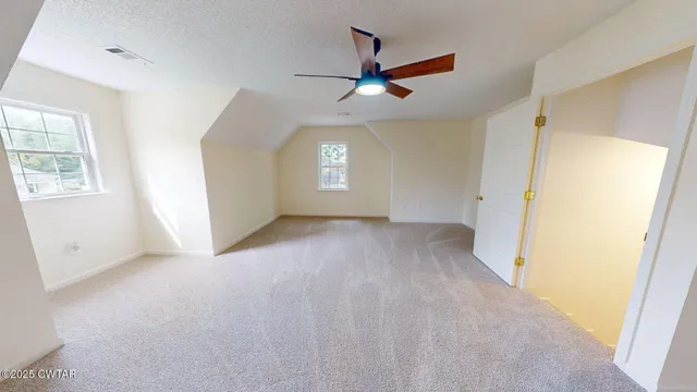 a view of an empty room and a window