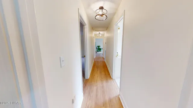 a view of walk in closet with wooden floor