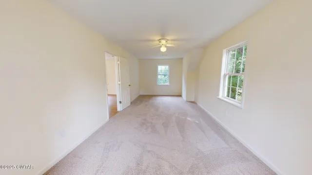 an empty room with windows and closet