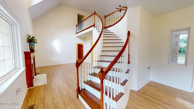 a view of entryway with wooden floor and stairs