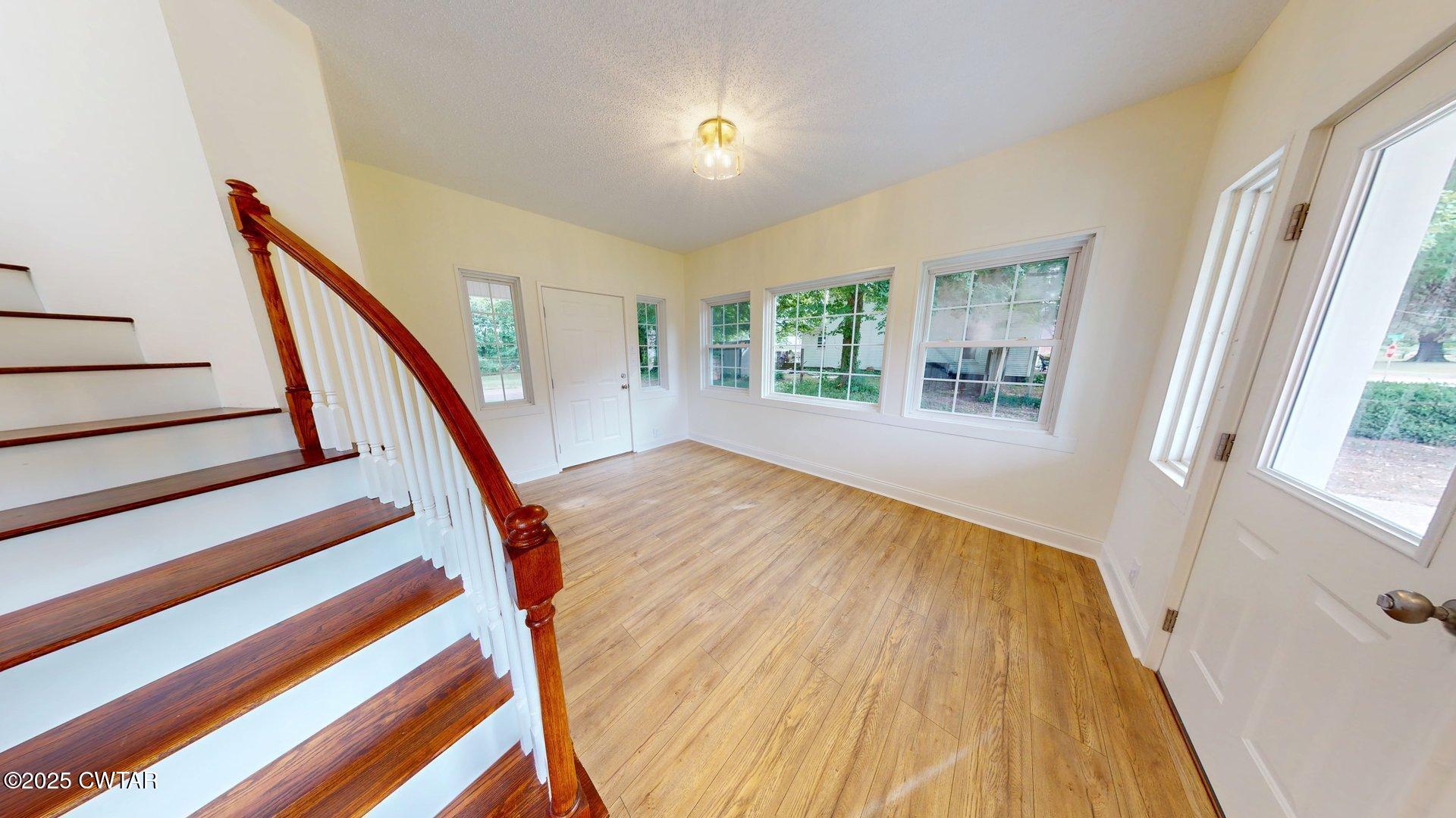 404 West Main Street Newbern, TN 38059 - Photo 4 of 35 a view of an entryway with wooden floor and stairs