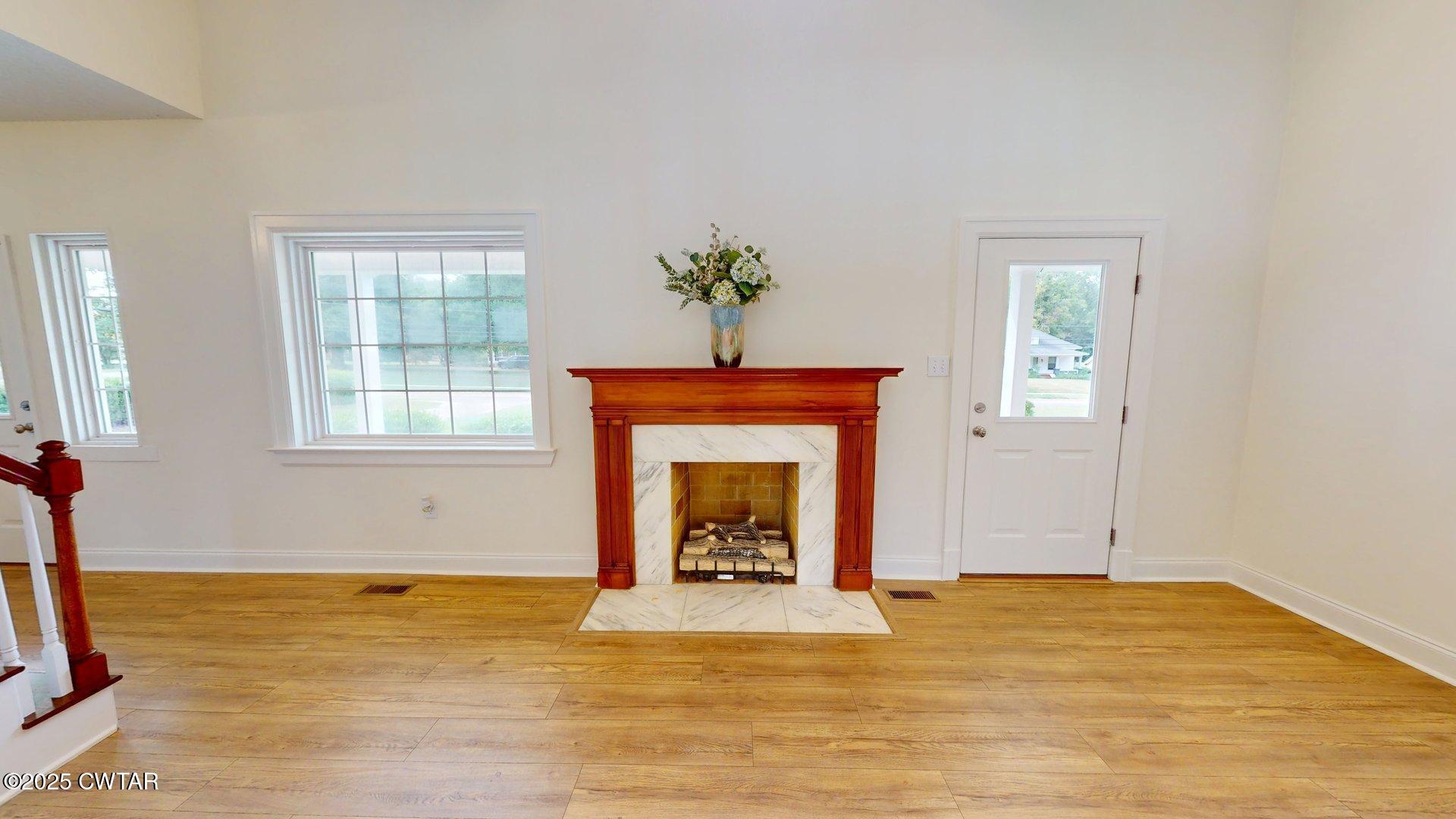 404 West Main Street Newbern, TN 38059 - Photo 5 of 35 a view of an empty room with window and fireplace