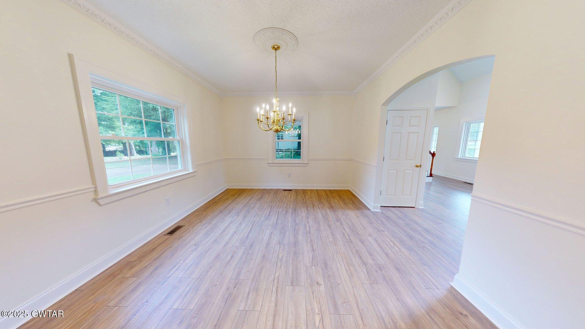 404 West Main Street Newbern, TN 38059 - Photo 7 of 35 a view of livingroom with hardwood floor and window