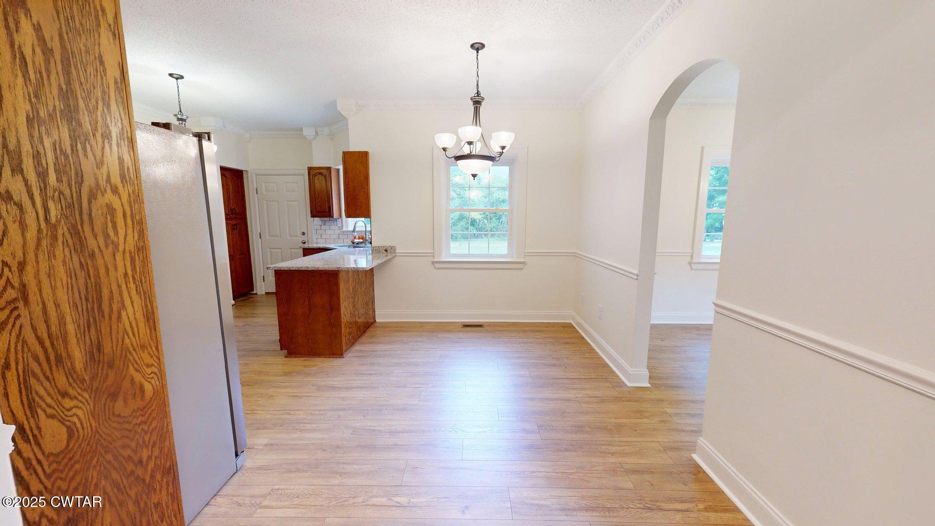 404 West Main Street Newbern, TN 38059 - Photo 8 of 35 wooden floor in an empty room with a window