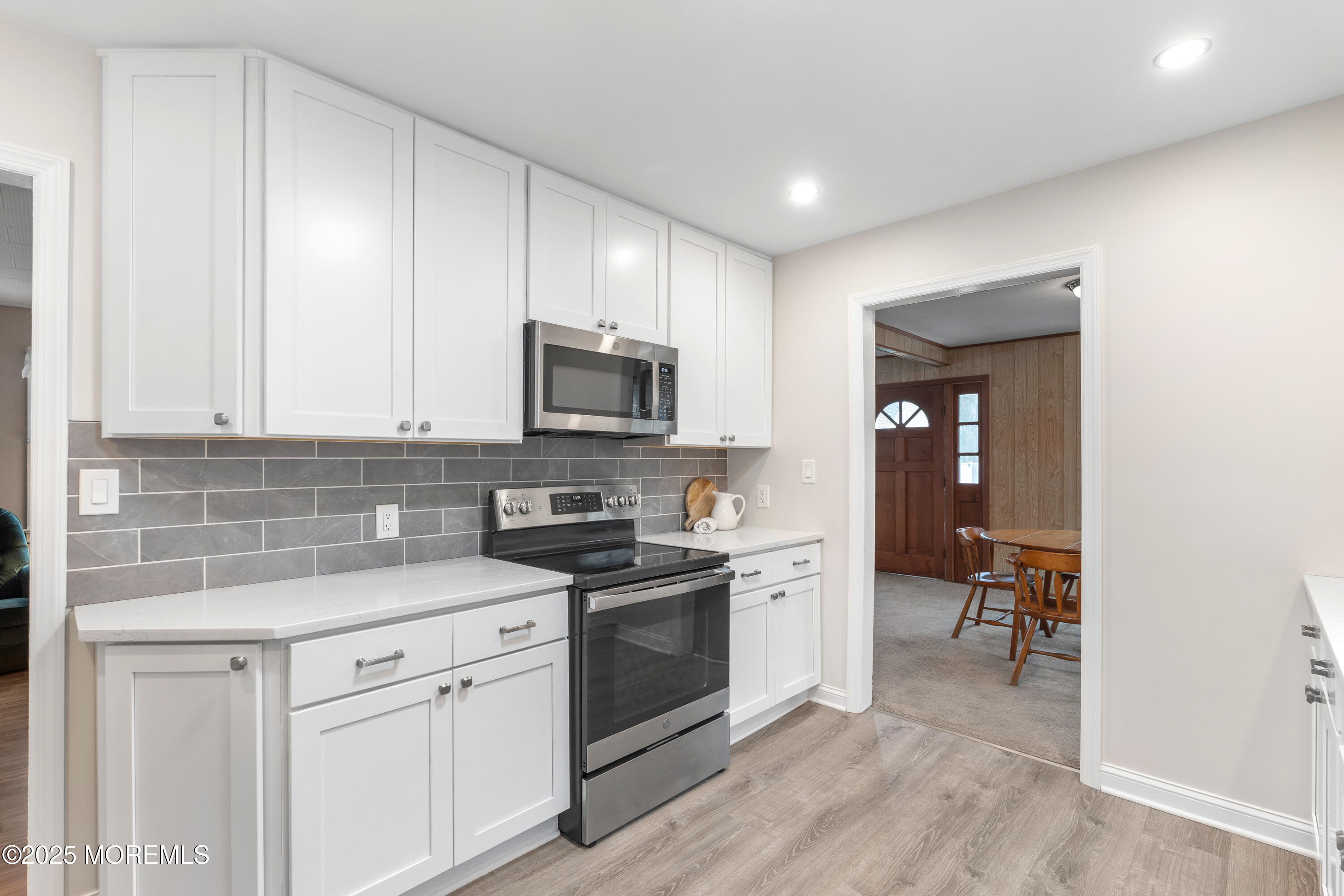 9 Monmouth Place Keyport, NJ 07735 - Photo 9 of 28 a kitchen with white cabinets and appliances