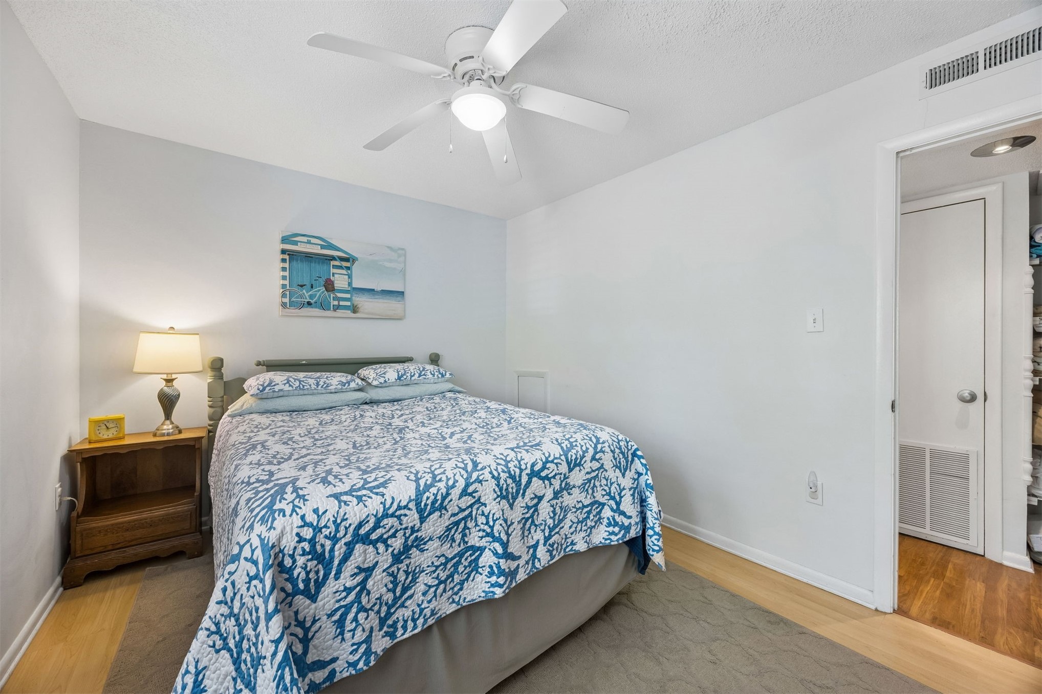 2328 Sadler Road, Unit 1C Fernandina Beach, FL 32034 - Photo 25 of 49 a bedroom with a bed and a chandelier